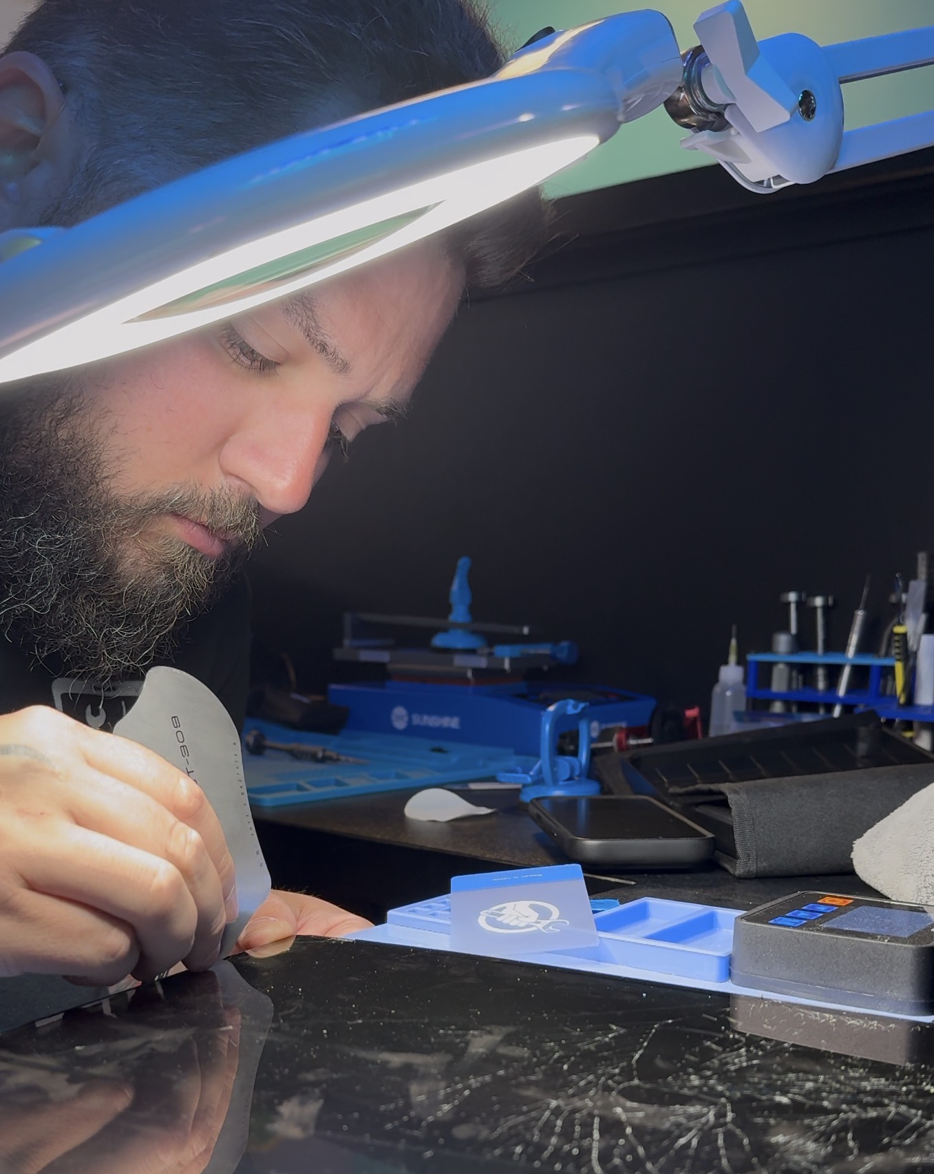 Kyle at his repair bench with professional tools